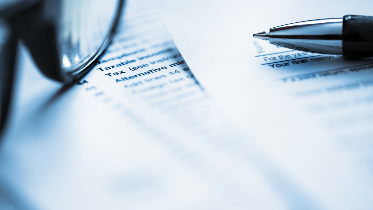 Tax forms and pen showing IRS debt forgiveness eligibility documentation requirements