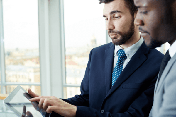 Business professionals consulting about tax attorney fees tax deductible expenses in modern office