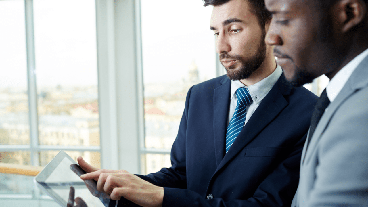 Business professionals consulting about tax attorney fees tax deductible expenses in modern office