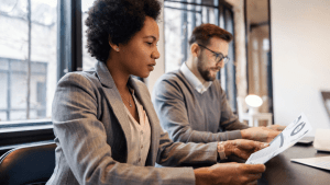 Two professionals reviewing documents in consultation meeting with tax attorney services