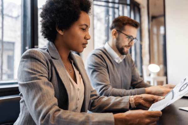 Two professionals reviewing documents in consultation meeting with tax attorney services