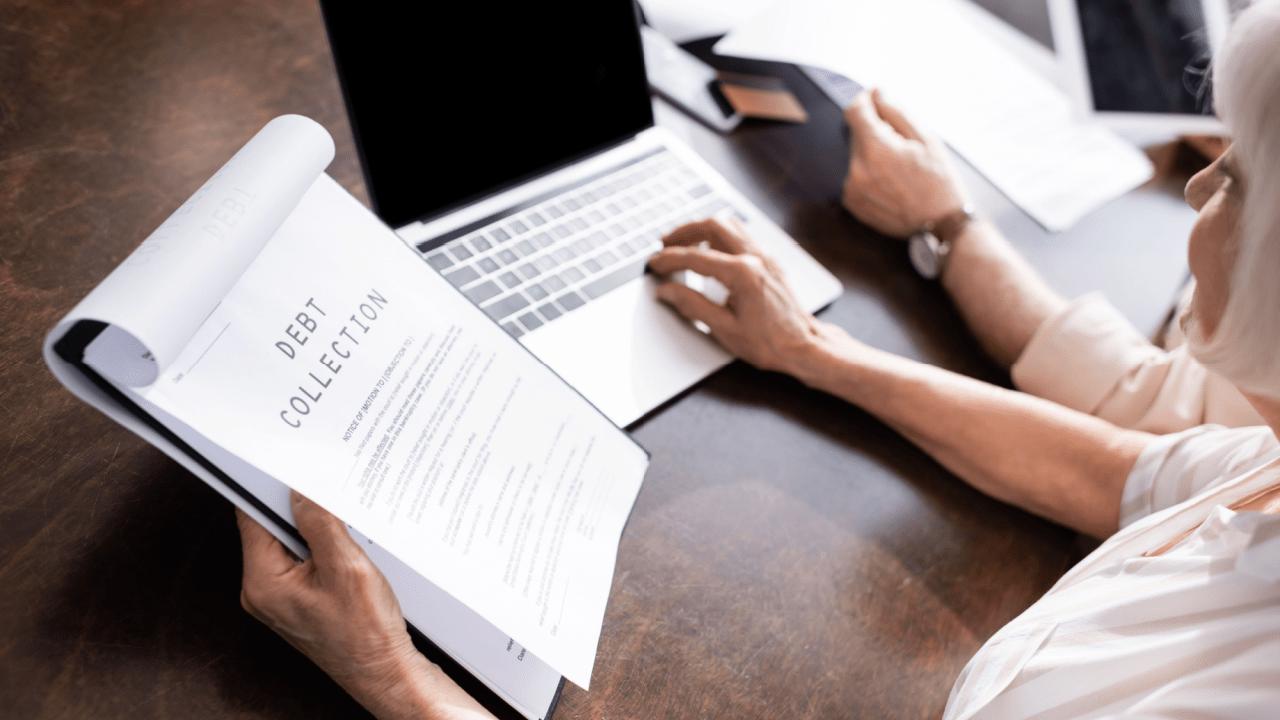 Person reviewing debt collection and lawsuits documentation while researching legal options on laptop