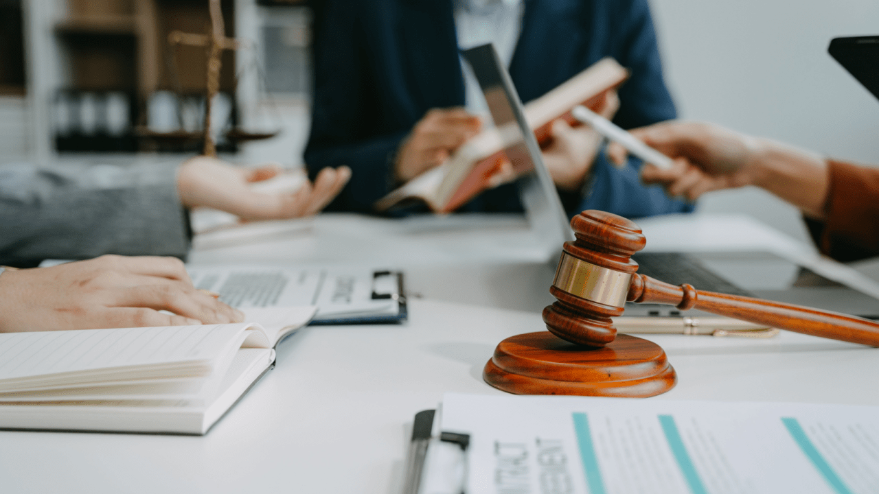 Tax lawyer and CPA consultation showing gavel, calculator, and legal documents to illustrate what is the difference between a tax lawyer and a tax CPA