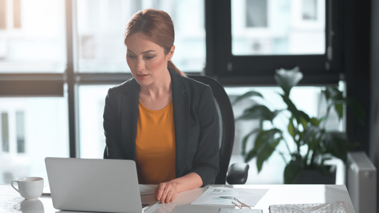Professional woman reviewing tax advocate vs attorney costs compared documents at modern office desk