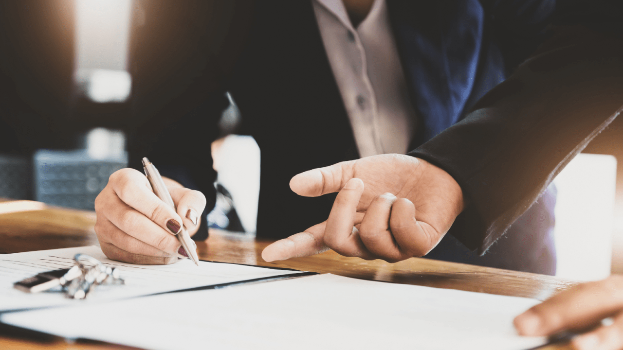 Professional CPA writing notes during tax consultation showing how can a CPA help with tax problems