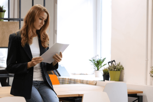 Woman reviewing tax documents wondering how many years does it take for IRS debt to be forgiven