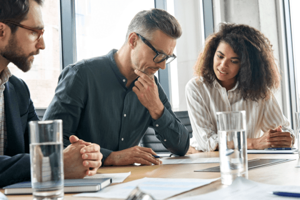 Tax professionals reviewing how to clear 30000 debt fast with client during consultation meeting