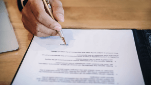 Professional signing legal documents with an IRS audit defense attorney for tax resolution services