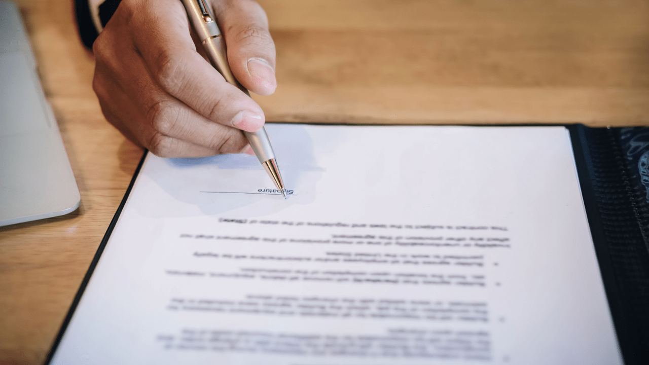 Professional signing legal documents with an IRS audit defense attorney for tax resolution services