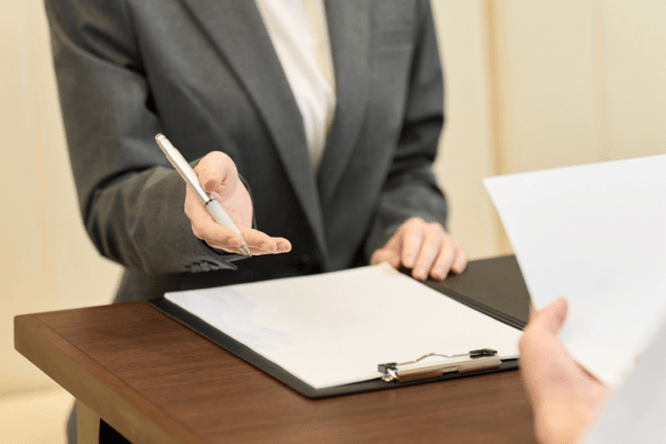 Professional tax attorney consulting with client about IRS settlement negotiation process using legal documents and paperwork