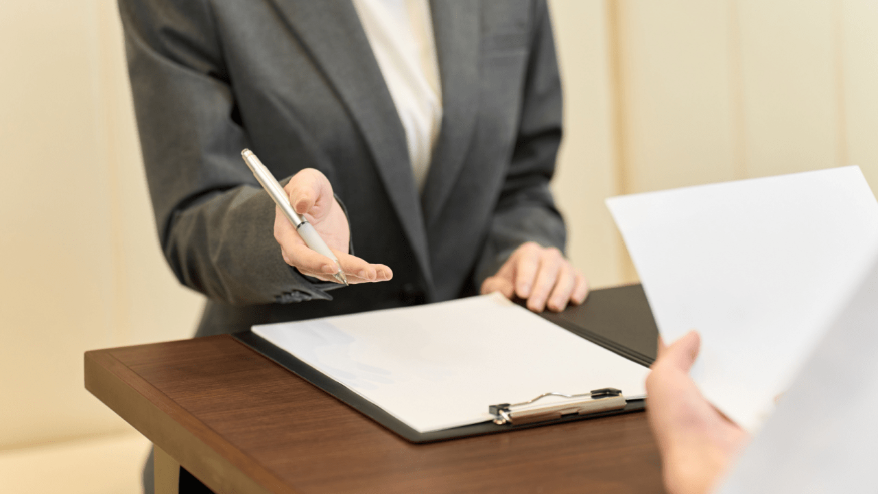 Professional tax attorney consulting with client about IRS settlement negotiation process using legal documents and paperwork