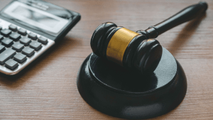 Judge gavel and calculator representing back taxes attorney help for IRS debt resolution