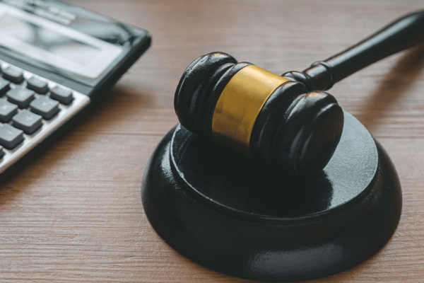 Judge gavel and calculator representing back taxes attorney help for IRS debt resolution