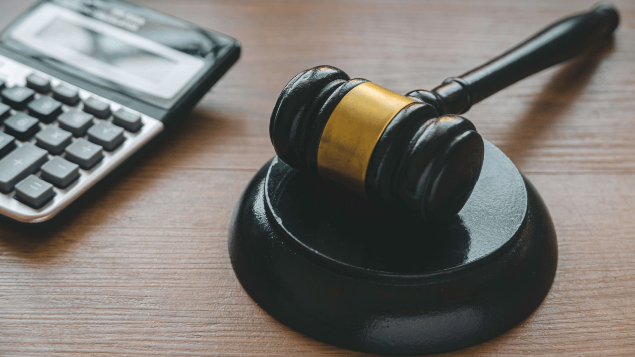 Judge gavel and calculator representing back taxes attorney help for IRS debt resolution