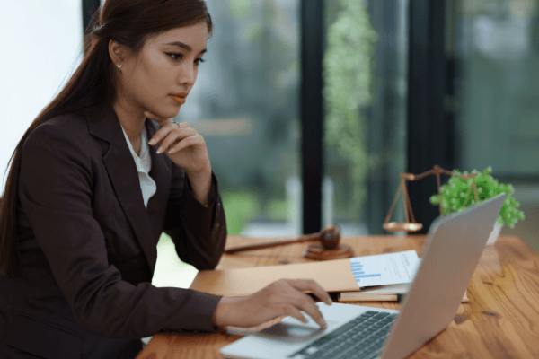 Professional woman tax attorney working at desk - does the IRS hire tax attorneys for legal compliance work