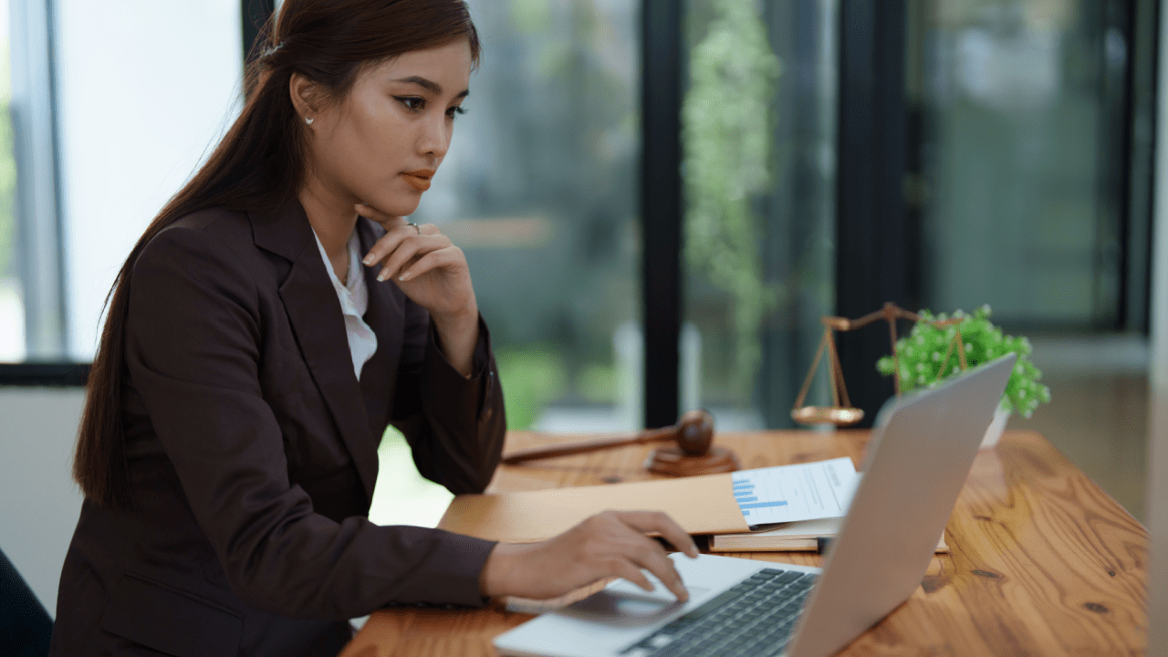 Professional woman tax attorney working at desk - does the IRS hire tax attorneys for legal compliance work