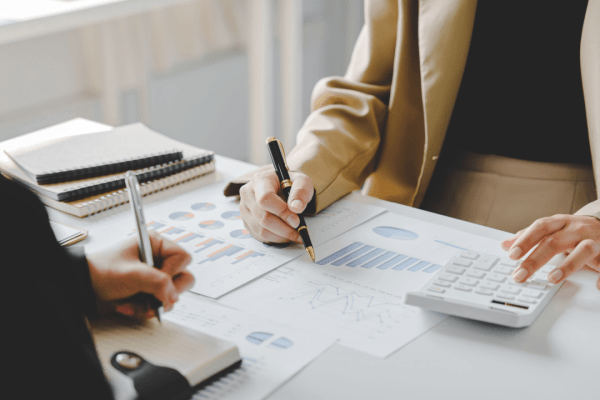 Professional reviewing financial documents and charts while deciding between tax lawyer vs CPA for IRS audits preparation