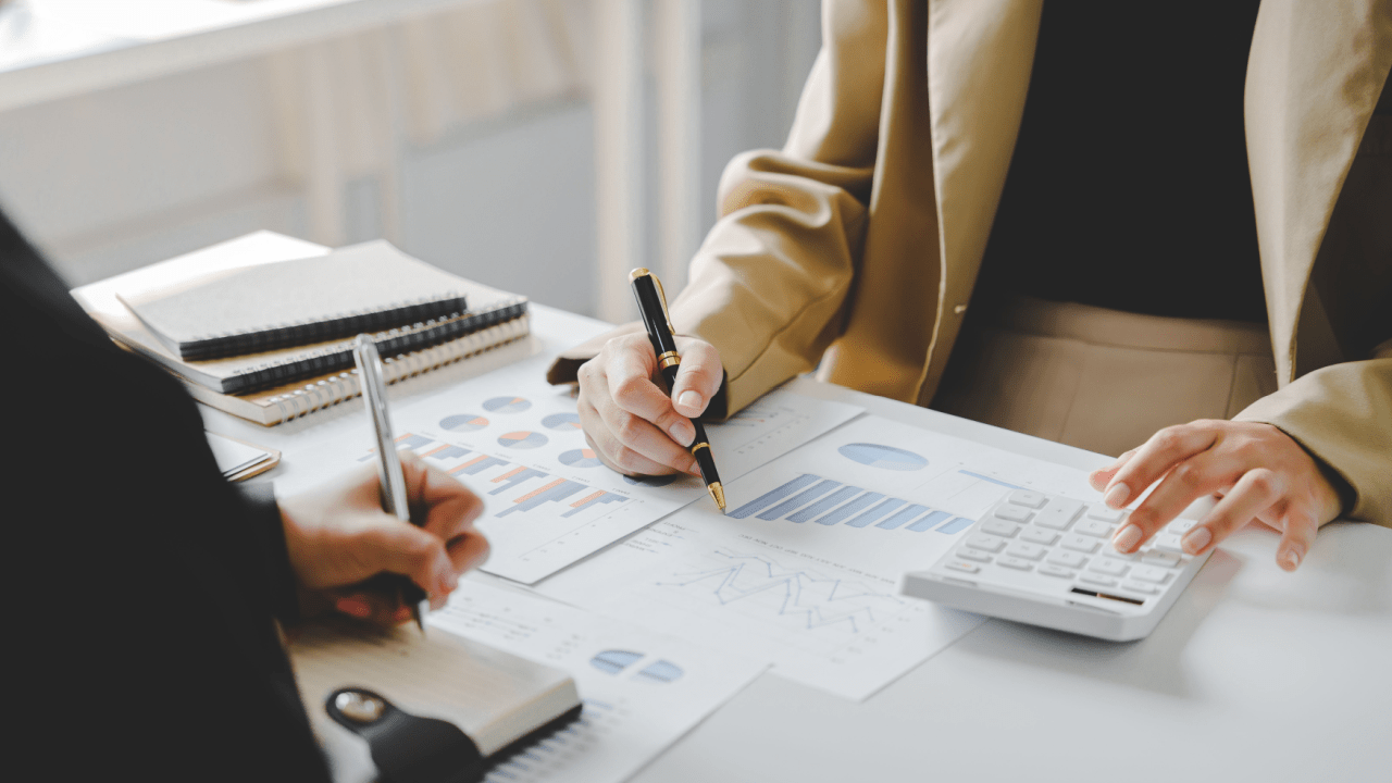 Professional reviewing financial documents and charts while deciding between tax lawyer vs CPA for IRS audits preparation