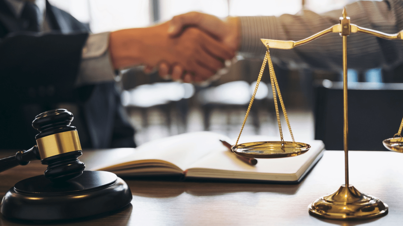 Legal consultation scene showing scales of justice and gavel representing what is the difference between a tax attorney and a tax lawyer