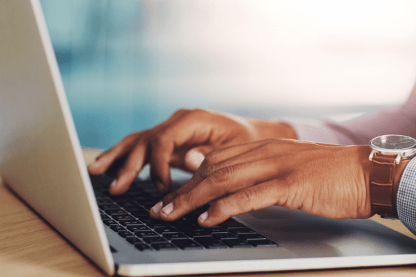 Professional hands typing on laptop researching when to seek a tax attorney for complex tax issues and legal representation needs