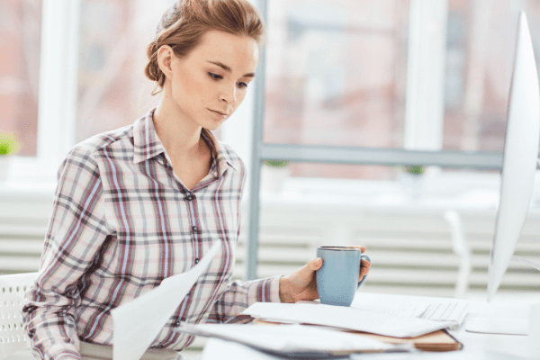 Woman reviewing tax documents to determine who qualifies for the IRS Fresh Start program