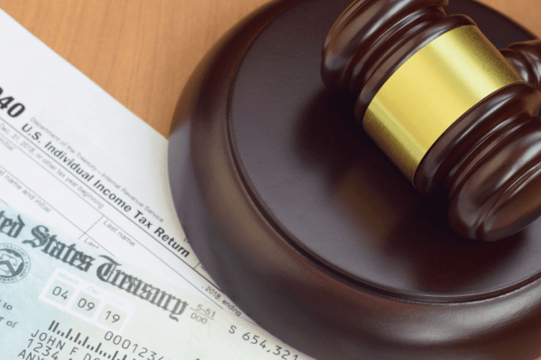 : Tax documents and gavel explaining why do people hire lawyers when dealing with the IRS