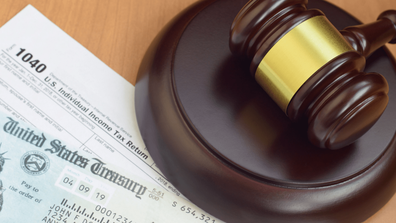 : Tax documents and gavel explaining why do people hire lawyers when dealing with the IRS