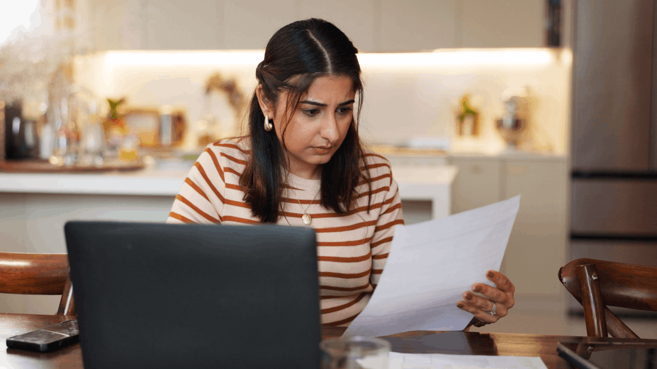 Woman researching does the IRS forgive tax debt after 7 years while reviewing financial documents at home