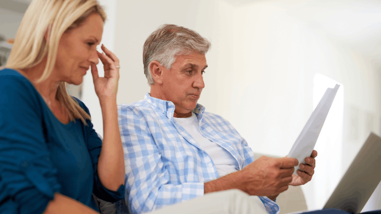 Couple reviewing IRS tax documents wondering how long will the IRS give you to pay your taxes