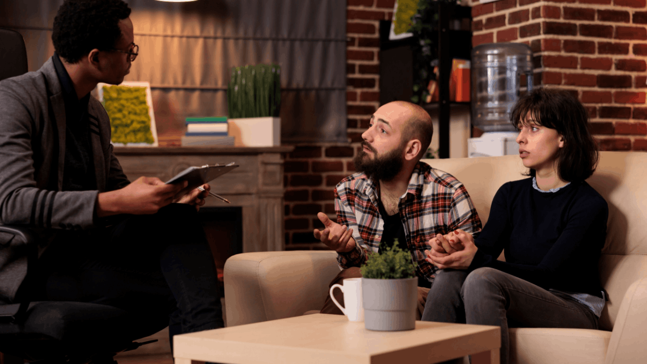 Couple seeking innocent spouse relief guidance from tax professional during home consultation about IRS tax liability