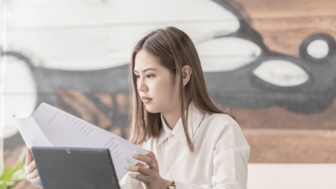 Woman reviewing financial documents to determine what debts are eligible for forgiveness through tax relief programs