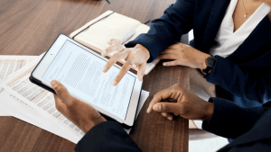 Tax professionals reviewing the four types of innocent spouse relief forms on tablet to help client understand IRS Form 8857 options