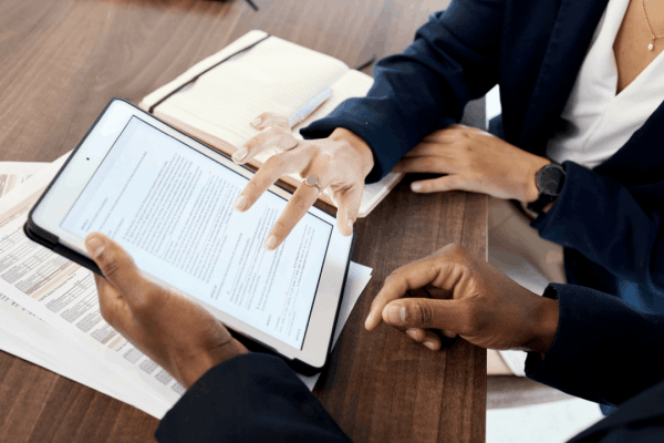 Tax professionals reviewing the four types of innocent spouse relief forms on tablet to help client understand IRS Form 8857 options