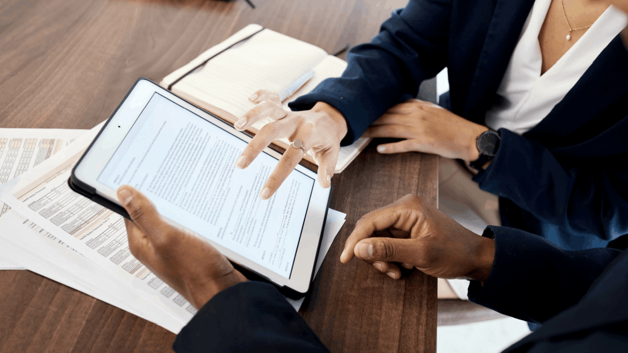 Tax professionals reviewing the four types of innocent spouse relief forms on tablet to help client understand IRS Form 8857 options