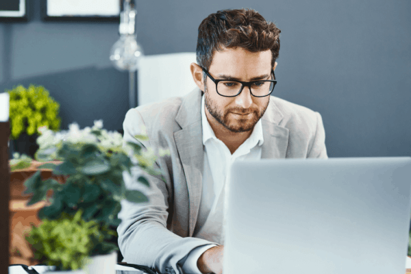 Professional tax attorney reviewing what is an example of a hardship for the IRS on laptop computer in modern office