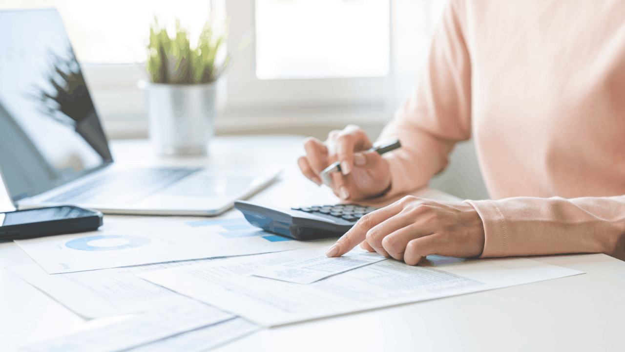 Executor reviewing deceased estate tax documents with calculator to understand 3-year rule for deceased estate filing deadlines