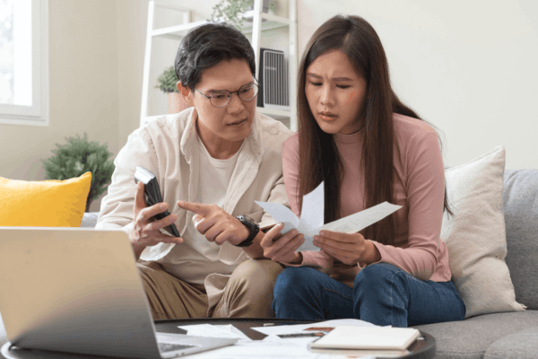 Couple reviewing tax documents worried about can the IRS come after my wife for my debt spousal liability issue