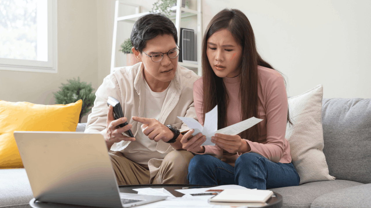 Couple reviewing tax documents worried about can the IRS come after my wife for my debt spousal liability issue