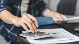 Does the IRS forgive debt after 10 years - taxpayer calculating tax debt with documents and calculator