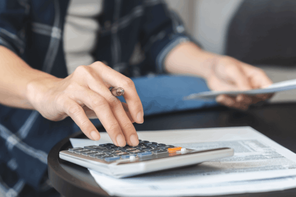 Does the IRS forgive debt after 10 years - taxpayer calculating tax debt with documents and calculator