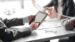 Tax professionals discussing how hard it is to get innocent spouse relief while reviewing case requirements and eligibility criteria on a tablet