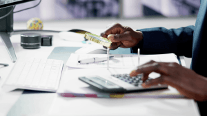 Tax professional reviewing documents with magnifying glass and calculator to determine how many days you have if the tax court denies your appeal Tax professional reviewing documents with magnifying glass and calculator to determine how many days you have if the tax court denies your appeal