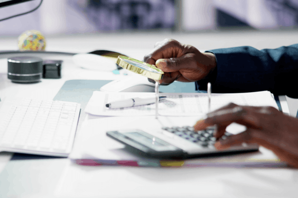 Tax professional reviewing documents with magnifying glass and calculator to determine how many days you have if the tax court denies your appeal Tax professional reviewing documents with magnifying glass and calculator to determine how many days you have if the tax court denies your appeal