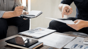 Tax professional explaining how to get innocent spouse relief while reviewing IRS documentation and requirements with client