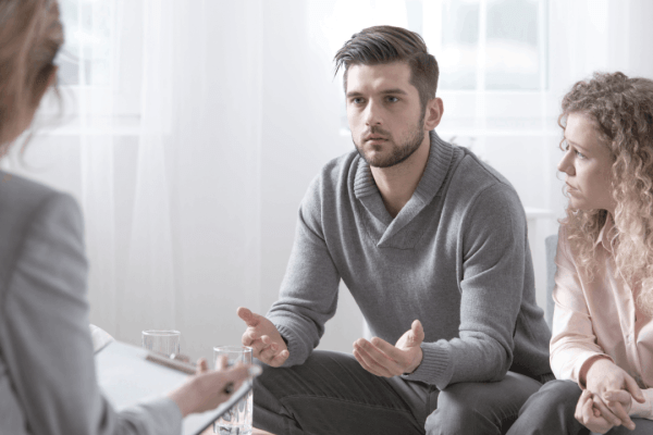 Couple consulting with a tax attorney about how to get a refund if granted innocent spouse relief