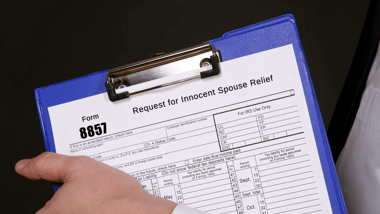 How to win innocent spouse relief Form 8857 request on clipboard showing IRS tax debt relief application