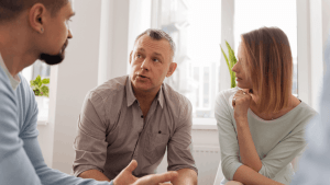 Couple consulting with tax professional about statute of limitations for innocent spouse relief and IRS tax debt options