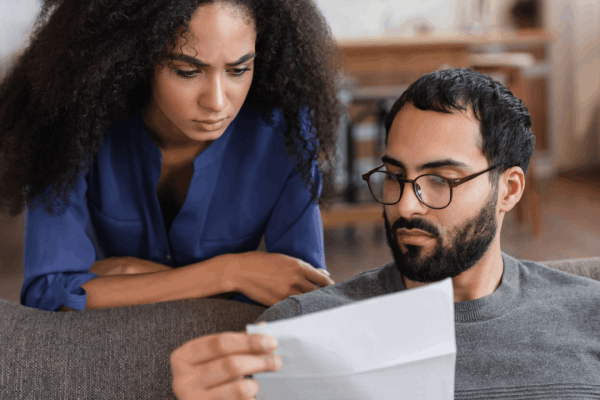 Couple reviewing IRS notice to determine who is eligible for innocent spouse relief from joint tax debt