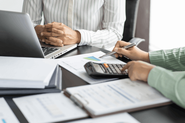 How do you know if the IRS wants to audit you — tax professional reviewing financial documents with a client