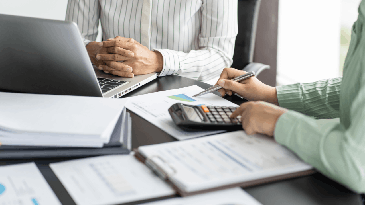 How do you know if the IRS wants to audit you — tax professional reviewing financial documents with a client
